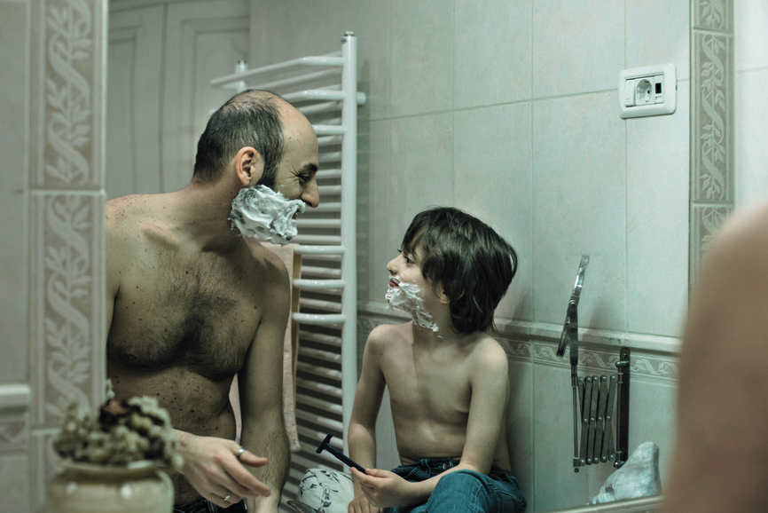 Father and son shaving together